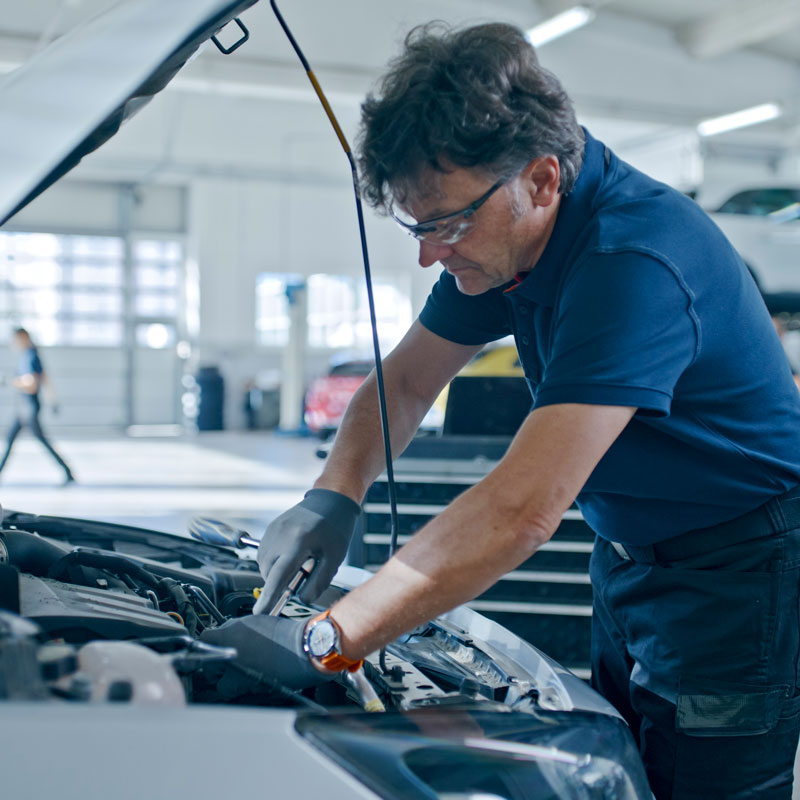 auto mechanic working on engine