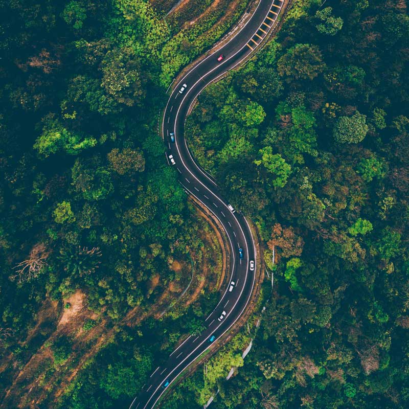 cars driving down windy road